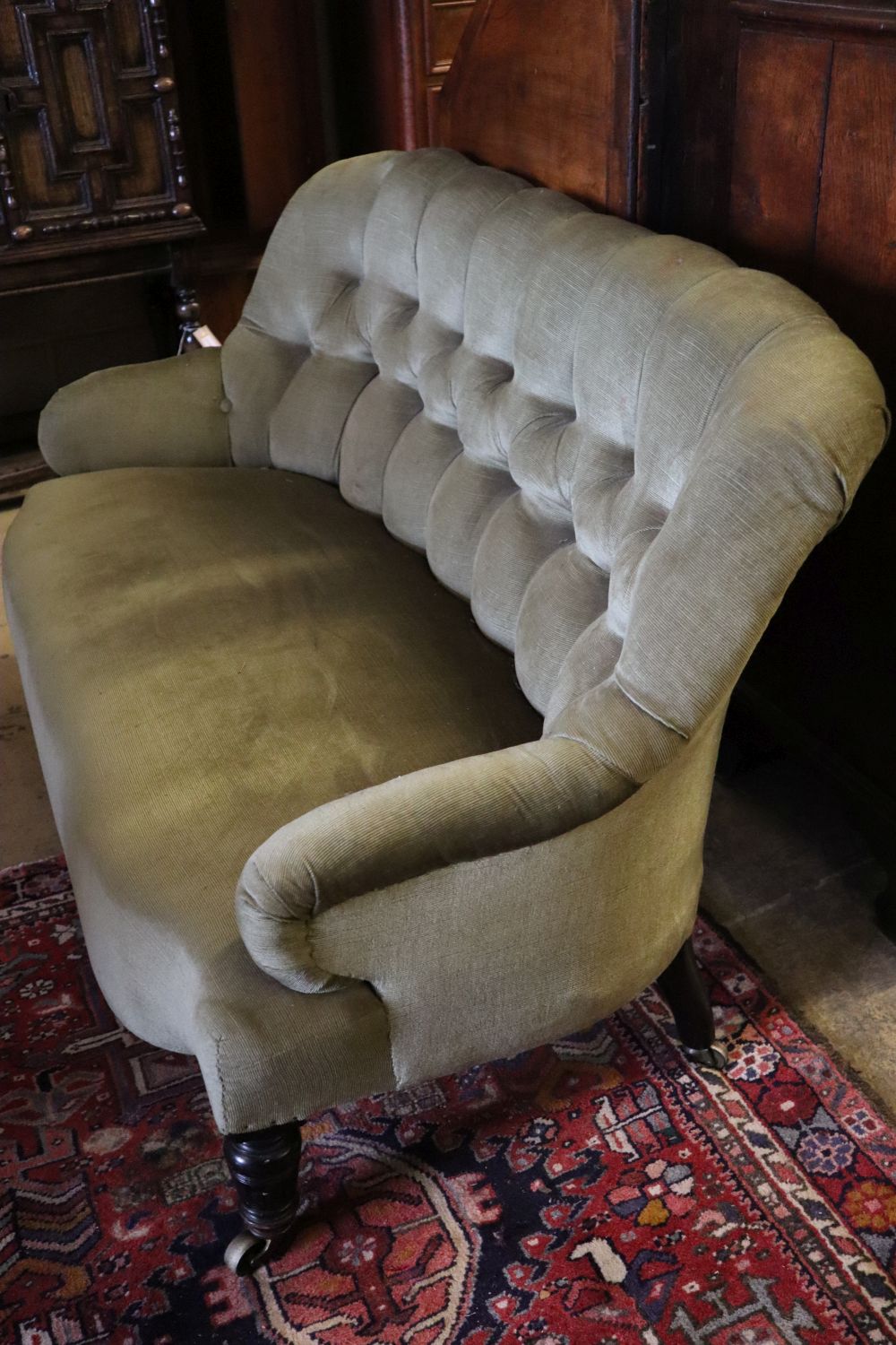 A late Victorian two-seater sofa upholstered in green corduroy, width 130cm depth 70cm height 80cm